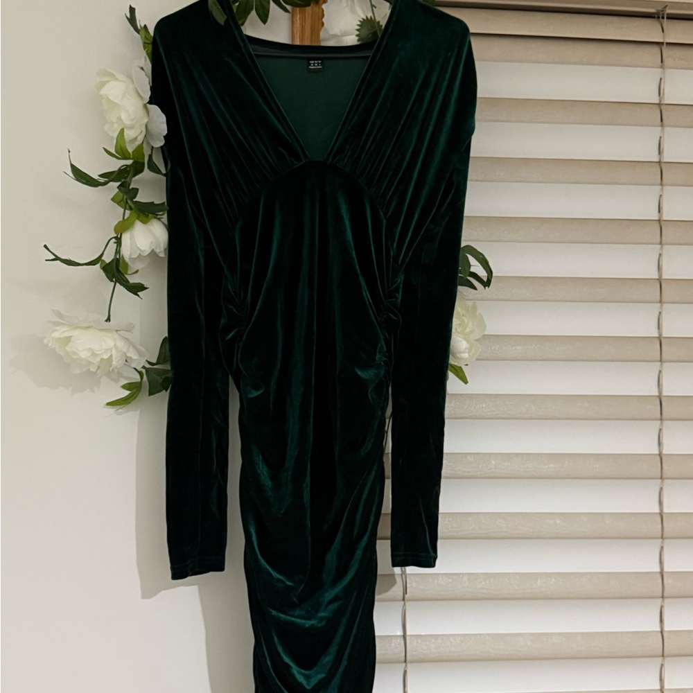 Tight green velvet dress withh ruffle sides that give pretty shape long sleeves